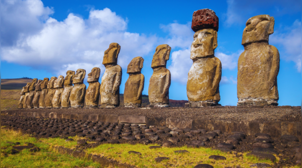 The enigmatic moai statues of Easter Island standing against the horizon.