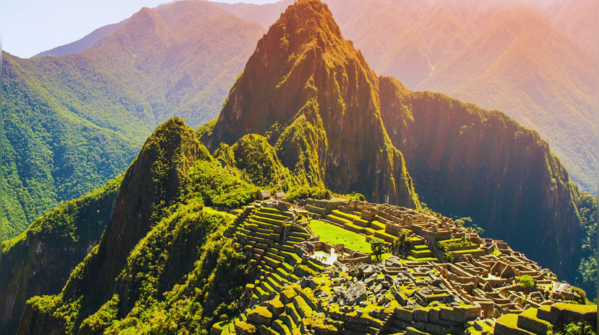 Machu Picchu nestled high in the Andes Mountains, shrouded in mist.