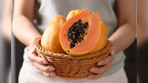 A vibrant and juicy papaya, sliced open to reveal its flesh.