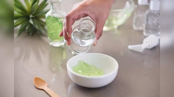 Applying aloe vera gel for hair growth and moisture.