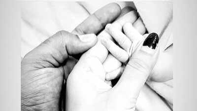 Mukesh Kumar and his wife Divya Singh pose with their newborn son.
